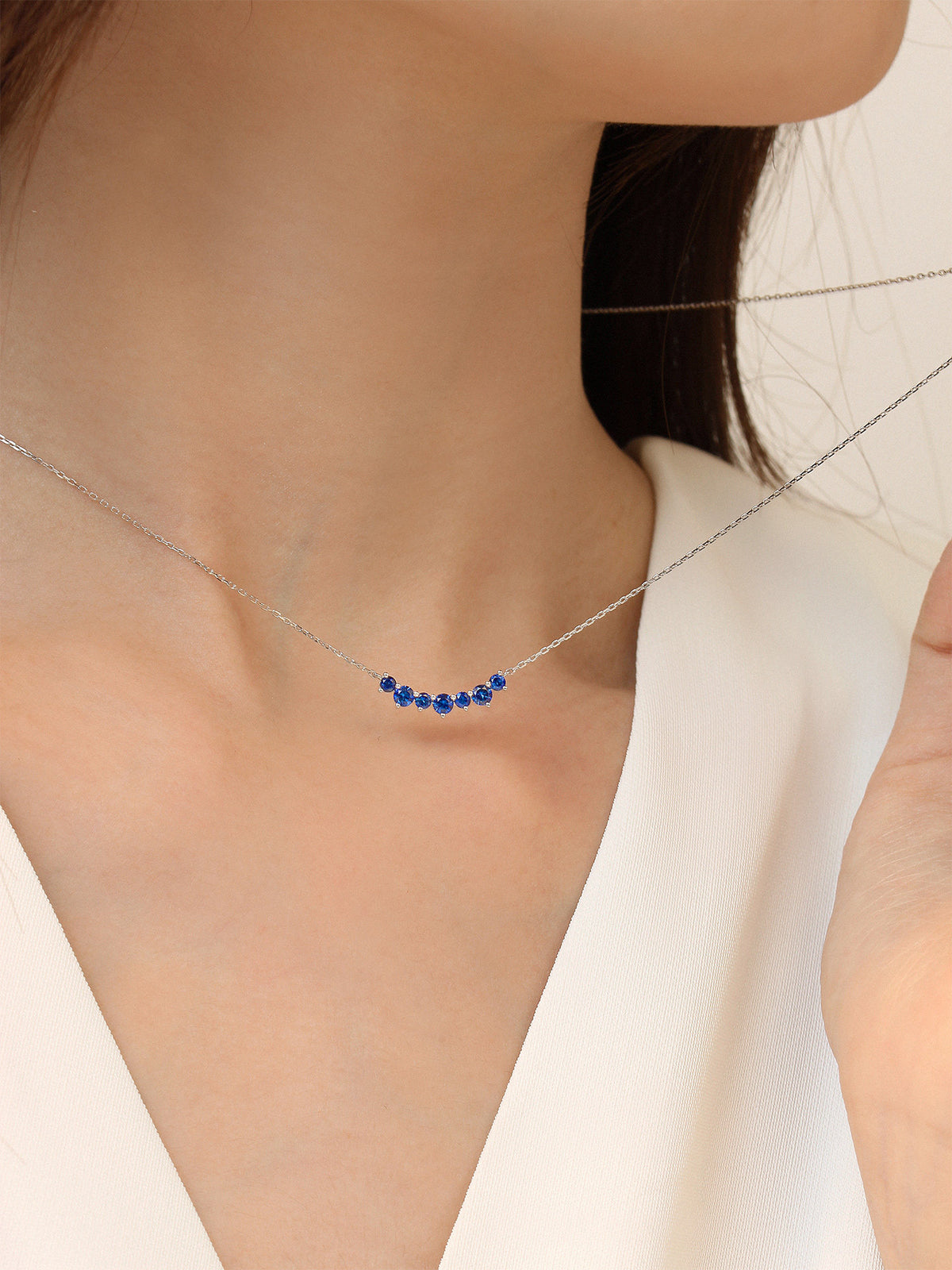 DANFÉE Seven-Stone Smile sapphire necklace worn at the collarbone