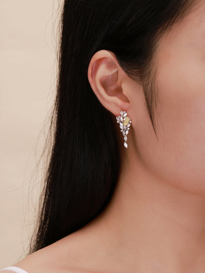 Side profile of yellow diamond drop earring worn on the ear