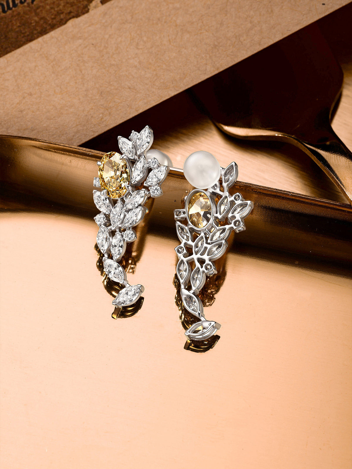 Front and back view of yellow diamond cluster earrings in 9K white gold showing claw settings